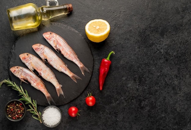 raw red mullet fish on stone background