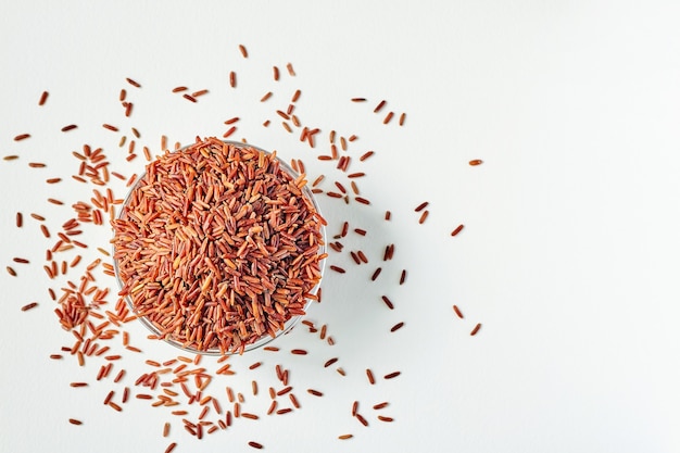 Raw red rice grains in a transparent glass plate