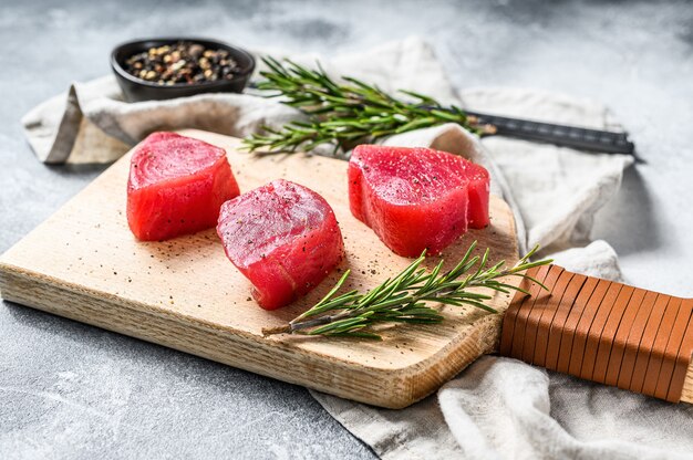 Raw red tuna steak. Gray background. Top view