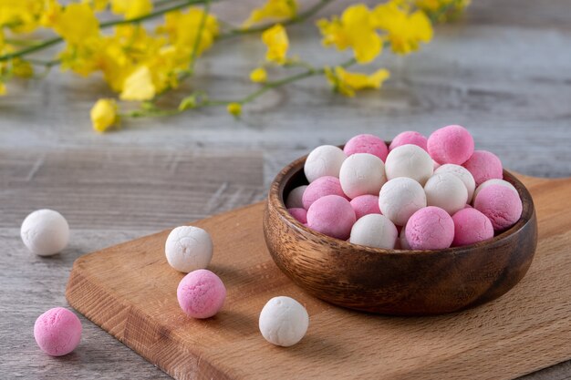 Raw red and white tangyuan glutinous rice dumpling balls. Winter solstice festival food.