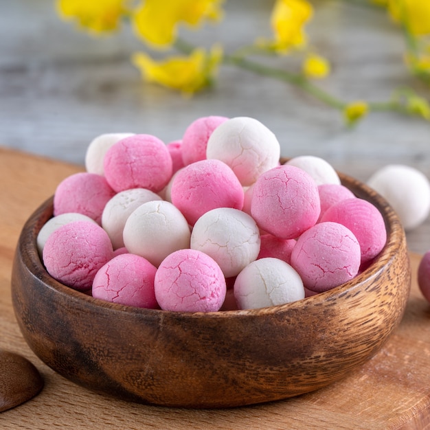 Raw red white tangyuan rice dumpling balls on wooden table