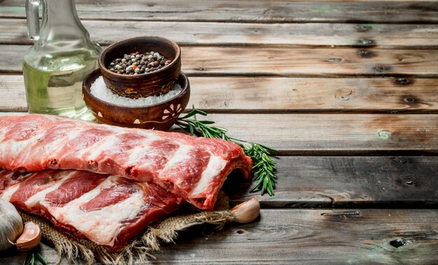 Raw ribs with spices and rosemary