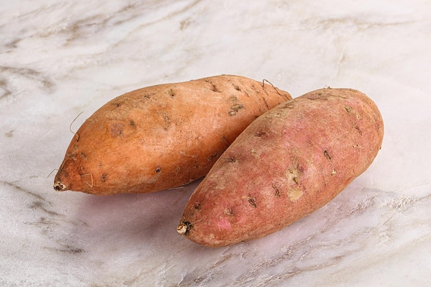 Raw ripe sweet potato heap for cooking