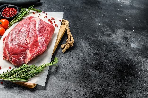 Raw Round beef cut on a cutting board