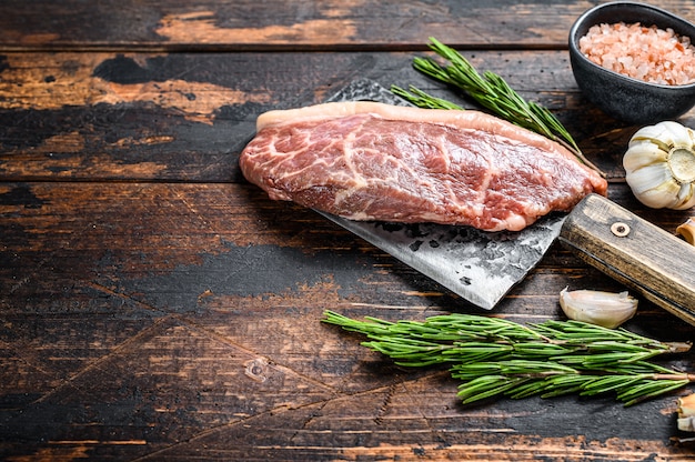 Raw rump cap steak on a meat cleaver