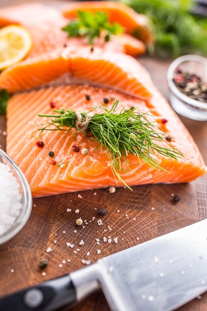 Raw salmon fillet with dill lemon olive oil salt and pepper.