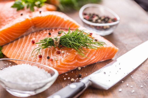 Raw salmon fillet with dill lemon olive oil salt and pepper.