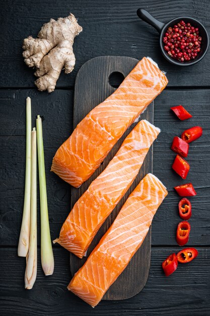 Raw salmon fillets on old wooden table