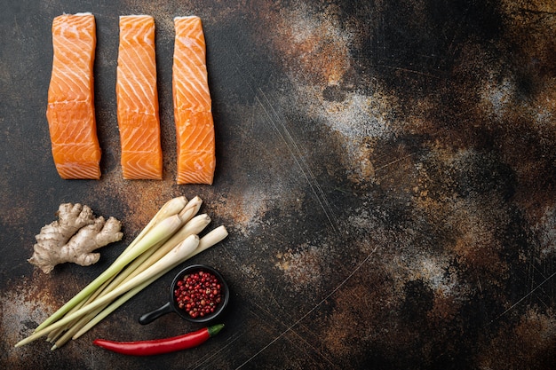 Raw salmon fillets on old wooden table