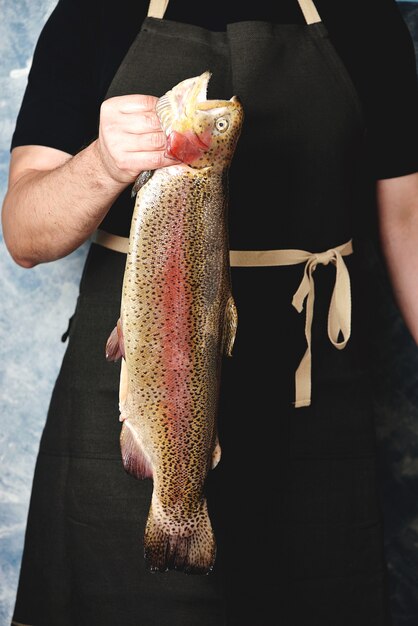 Raw salmon in male hands