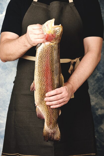 Raw salmon in male hands