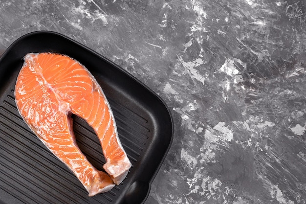 Raw salmon steak in a grill pan red fish