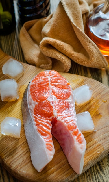 Raw salmon steak on the kitchen table.