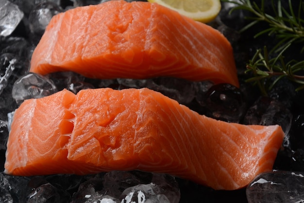 Raw salmon steaks on ice background