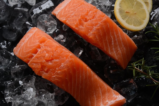 Raw salmon steaks on ice background