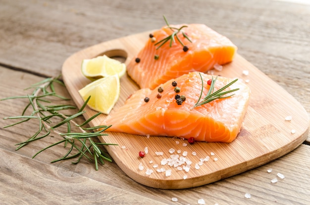 Raw salmon steaks on the wooden board