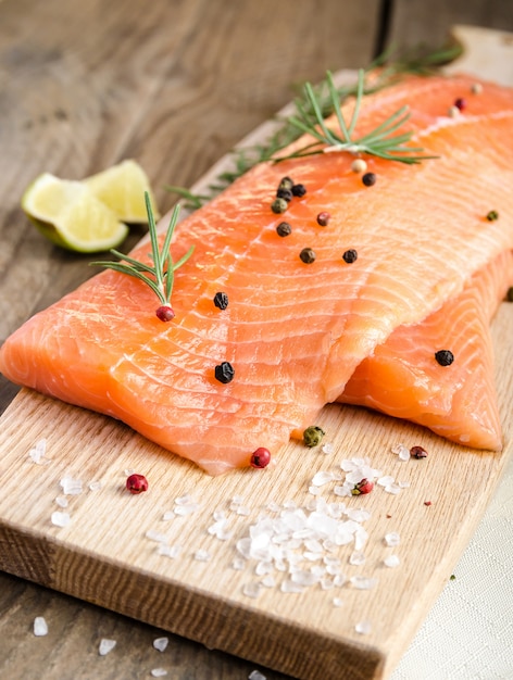 Raw salmon steaks on the wooden board