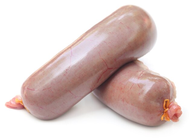 Raw sausage over white background