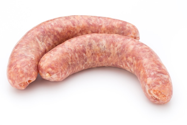 Raw sausage with parsley leaf isolated on white table