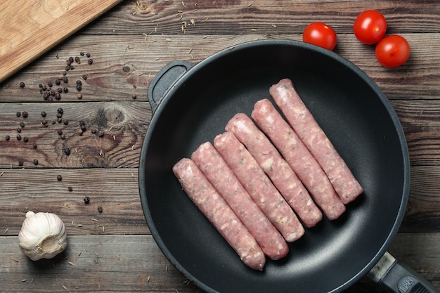 Raw Sausages in a Pan. Top view