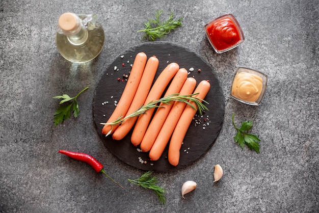 raw sausages on stone background