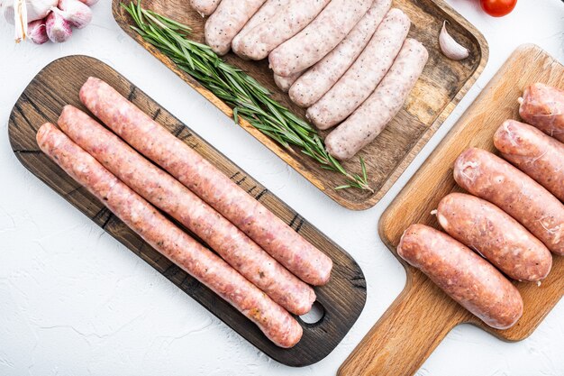 Raw sausages on white background