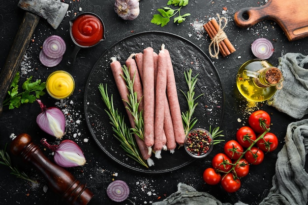 Raw sausages with rosemary and vegetables Top view Free space for your text