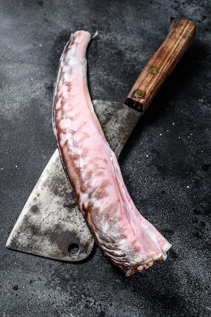 Raw sea eel fish on a cleaver.