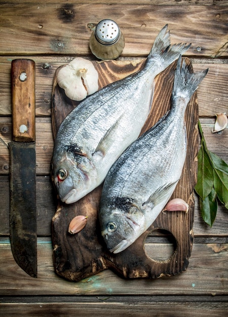 Raw sea fish dorado with herbs and aromatic spices