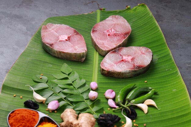 Raw Seer fish or Ayakura steaks of seer fish arranged on a fresh green banana leaf