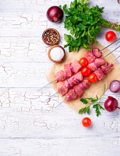 Raw shish kebab skewers  with tomatoes