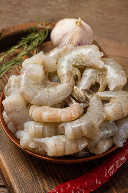 Raw shrimps oin a bowl on wooden