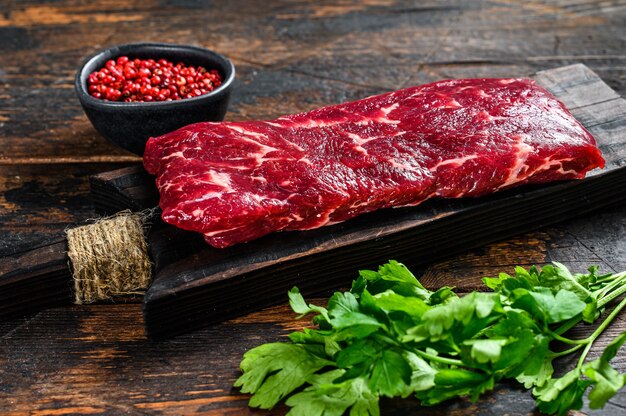 Raw skirt or machete beef meat steak on a cutting board