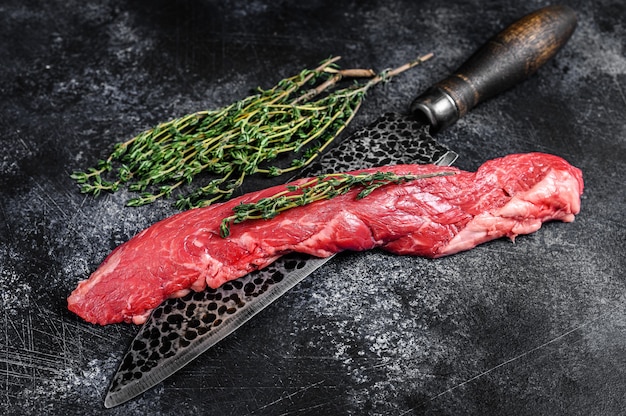 Raw skirt machete beef steak on a meat cleaver