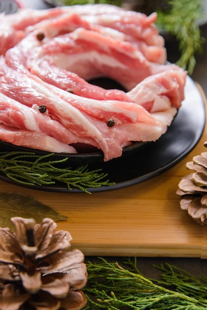 Raw sliced bacon pork for preparing a dinner for a Christmas dishes  with a Christmas decorations