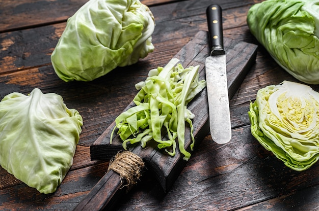 Raw sliced Pointed white cabbage on a cutting board.