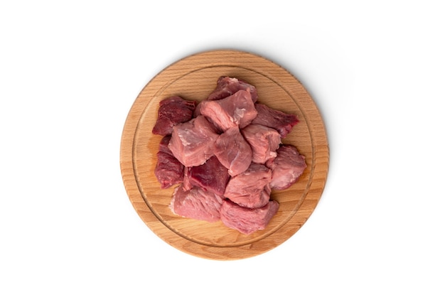 Raw sliced pork meat on wooden board isolated.