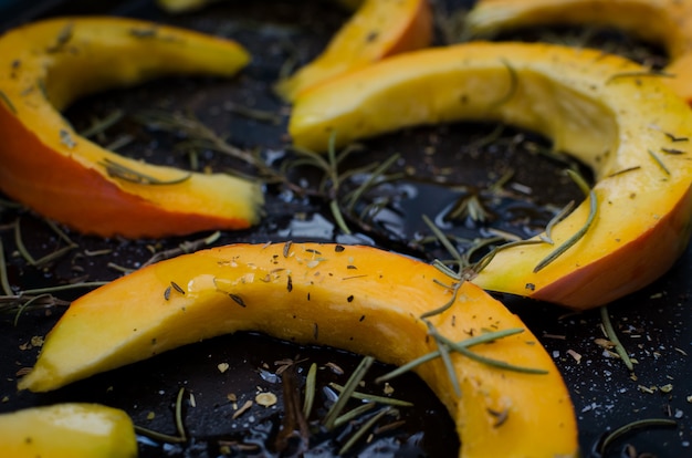 Raw sliced pumpkin on a baking tray