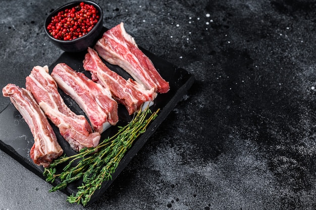 Raw sliced veal spare loin ribs on a marble board