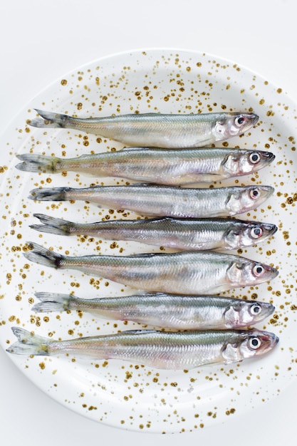 Raw smelt on a plate. 