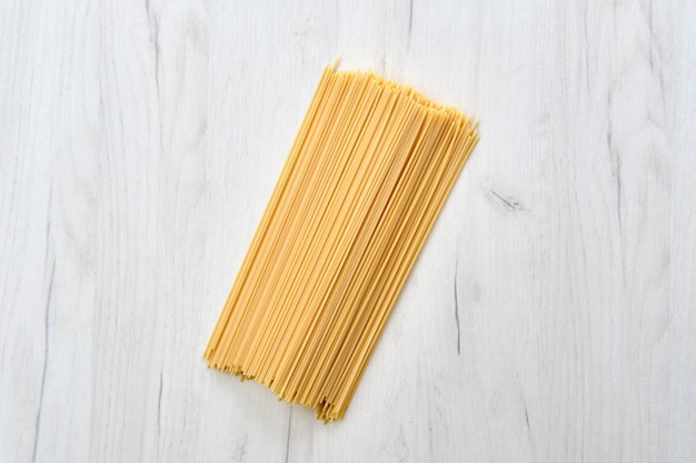 Raw spaghetti on wooden table