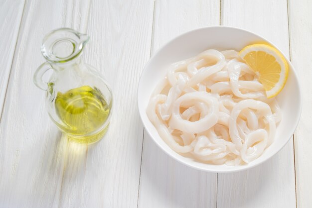 Raw squid ​​rings on a white plate ready for cooking