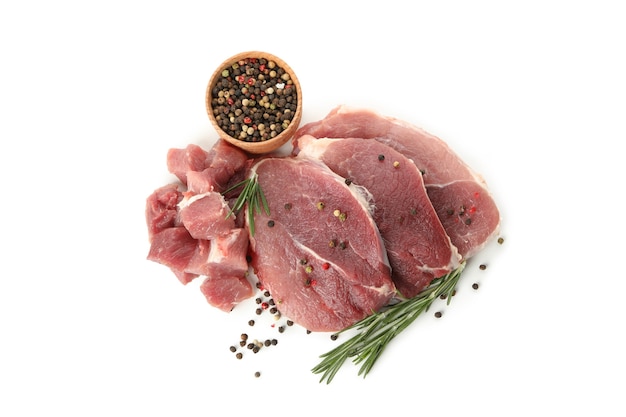 Raw steak meat with herbs and spices isolated on white