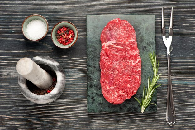 Raw steak Ribeye entrecote on dark wooden background