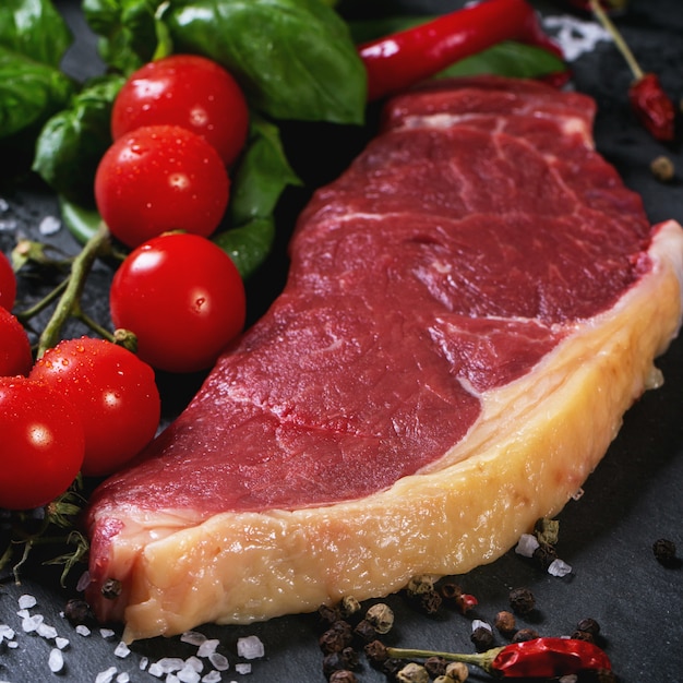 Raw steak with vegetables