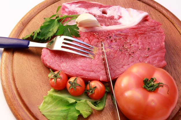 raw steak on wooden board