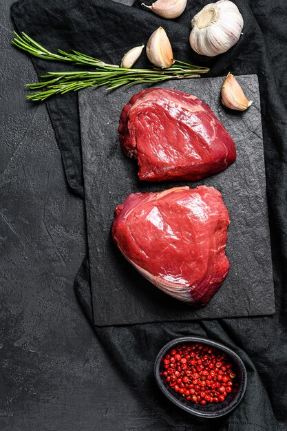 Raw steaks fillet Mignon prepared for cooking. Beef tenderloin. Top view