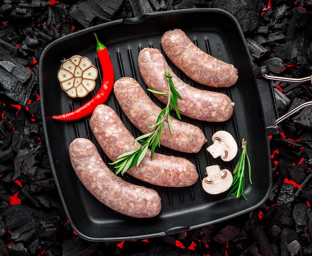 Raw stuffed sausages on srill pan