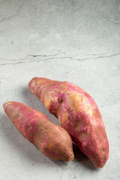 Raw sweet potato on the table