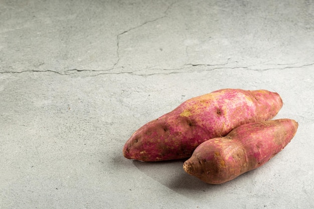 Raw sweet potato on the table